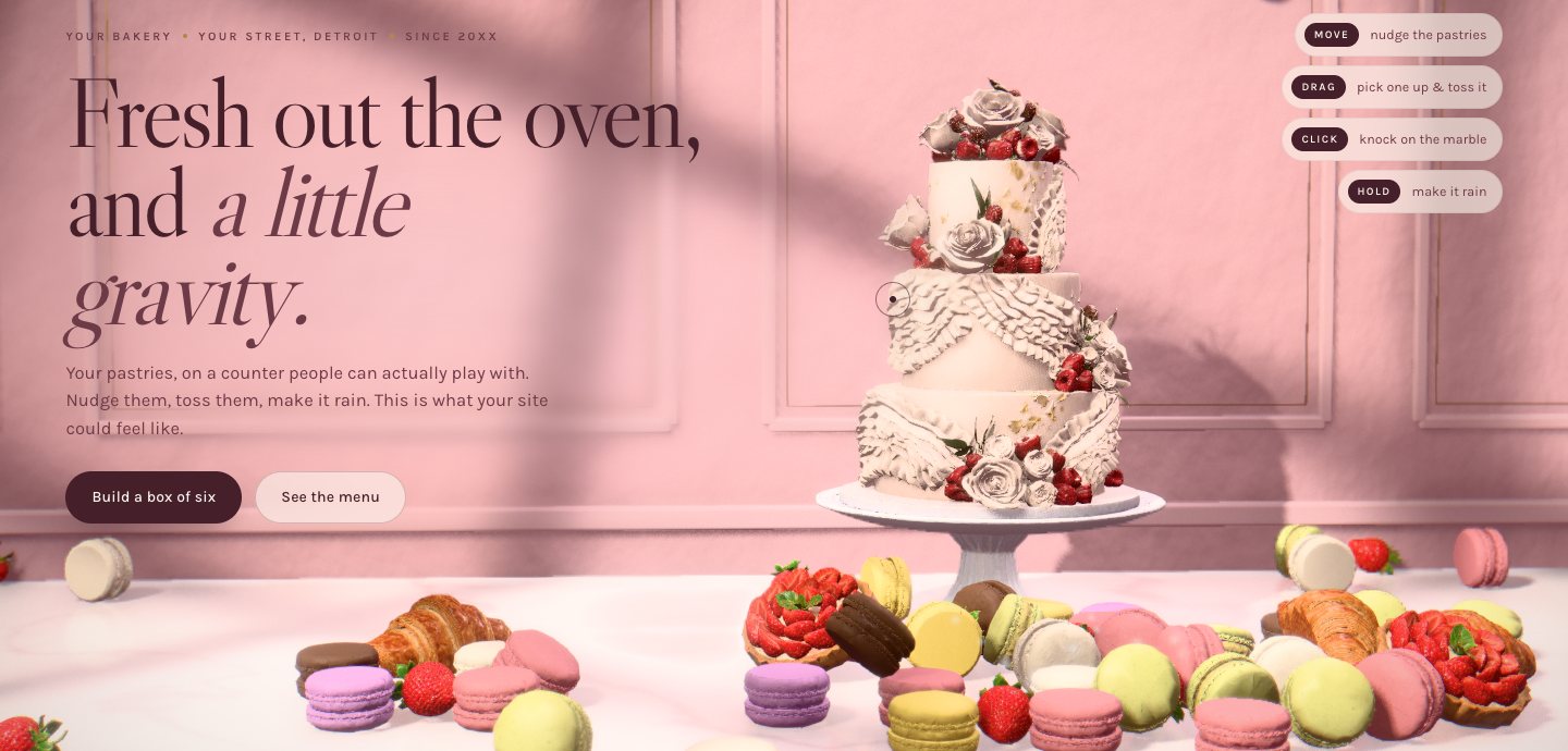 Sample bakery site in real 3D: a tiered cake on a stand above a marble counter piled with macarons, croissants and tarts